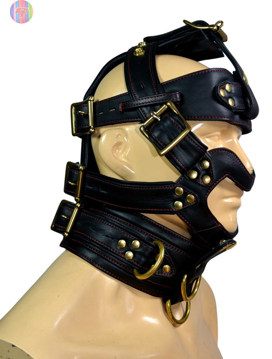 Black leather dog muzzle hood with spikes, brass hardware, and adjustable straps for BDSM and puppy play.