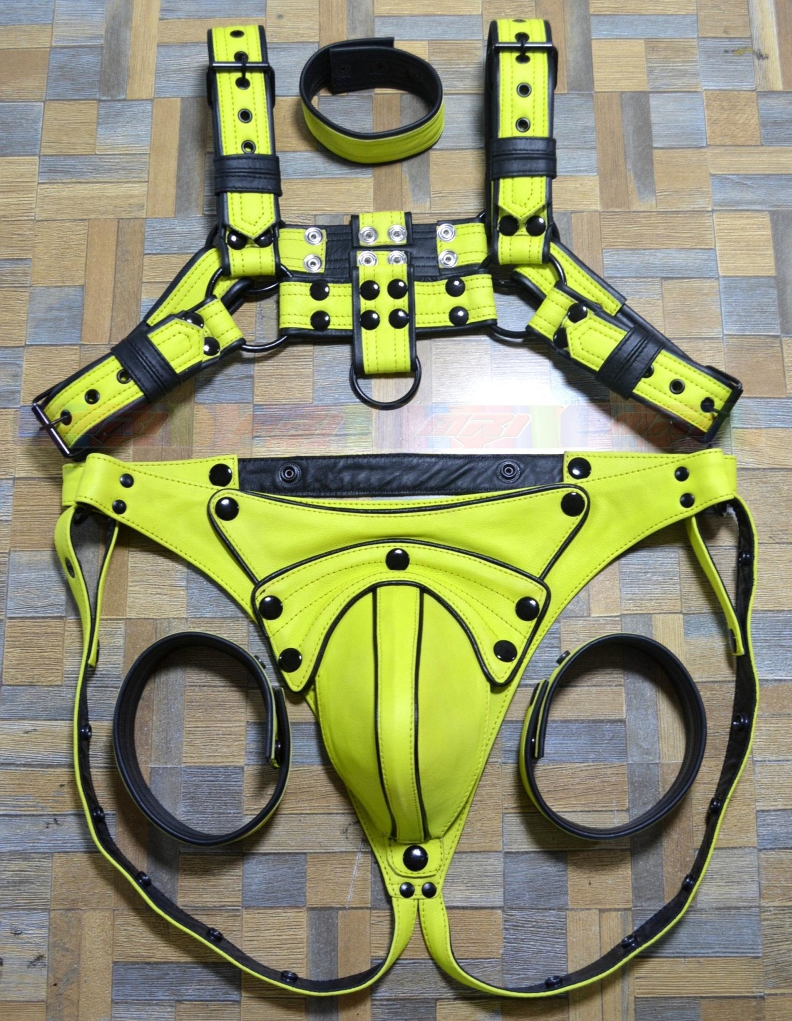 Men's adjustable body chest leather harness with yellow and black design, includes jock and arm bands.