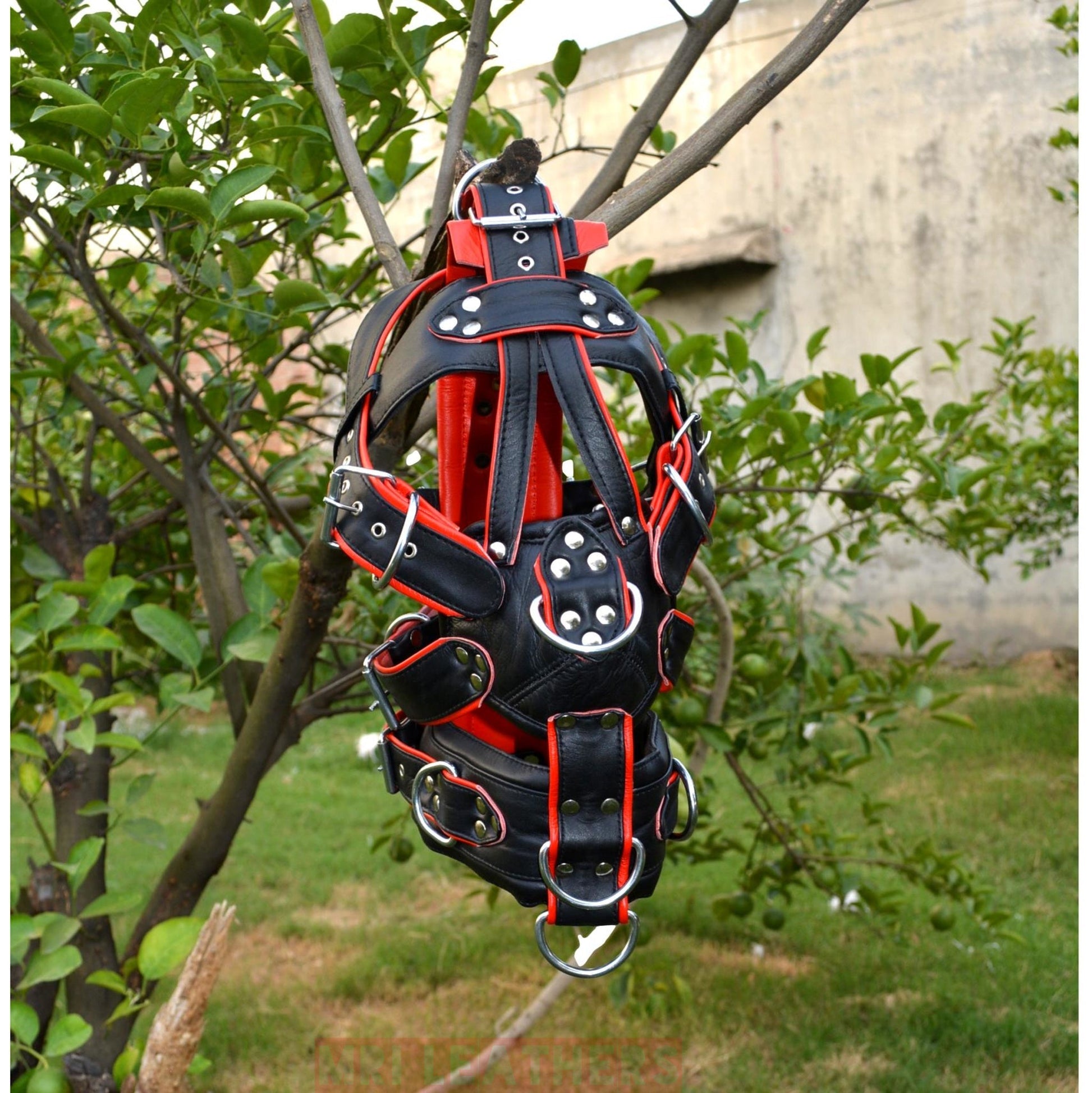 Leather BDSM gear face hood with D-rings and buckles for extreme bondage.