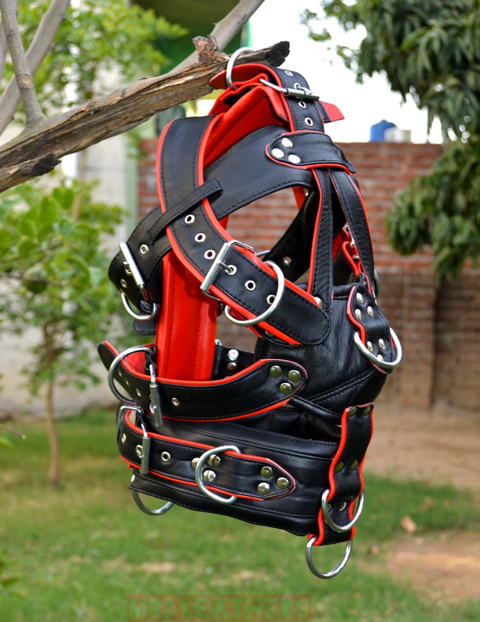 Leather BDSM gear face hood with D-rings and adjustable harness.