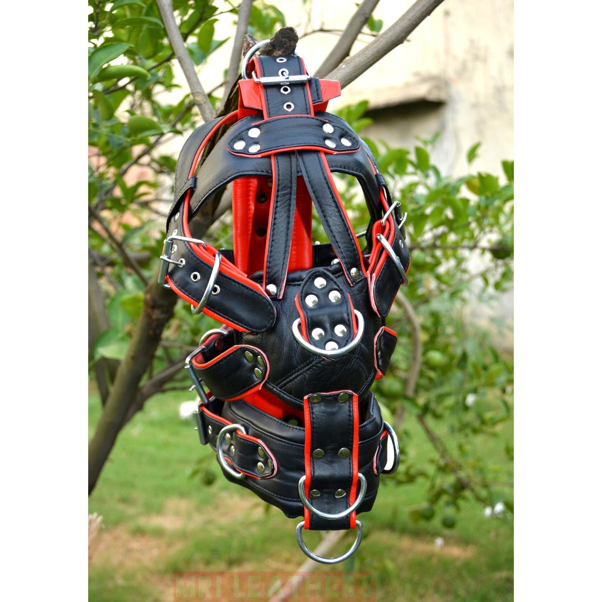 Leather gear face hood with D-rings for extreme bondage and restraint, featuring adjustable belts and padded muzzle.
