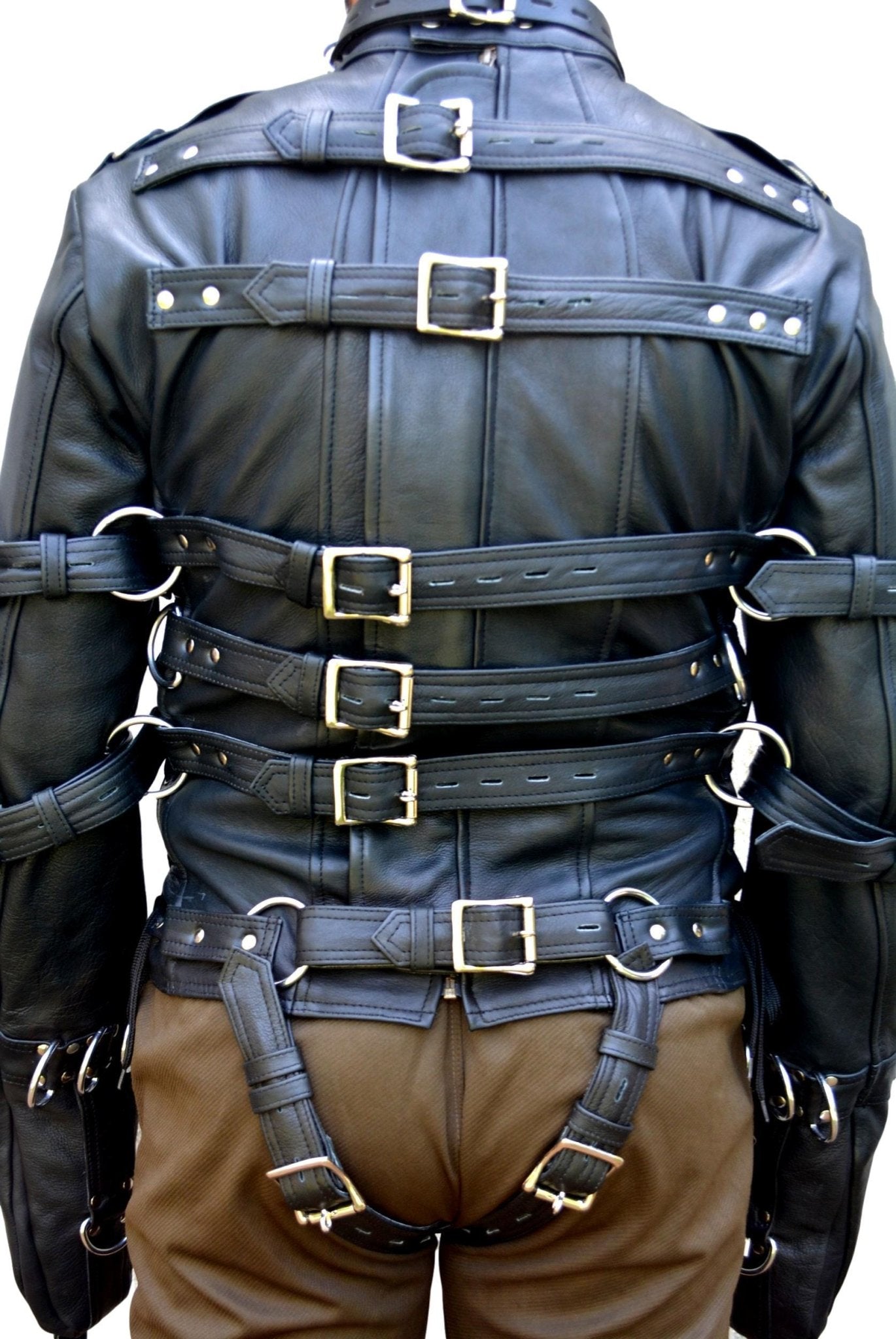 Heavy-duty real leather straitjacket with multiple straps and D-rings for extreme bondage.